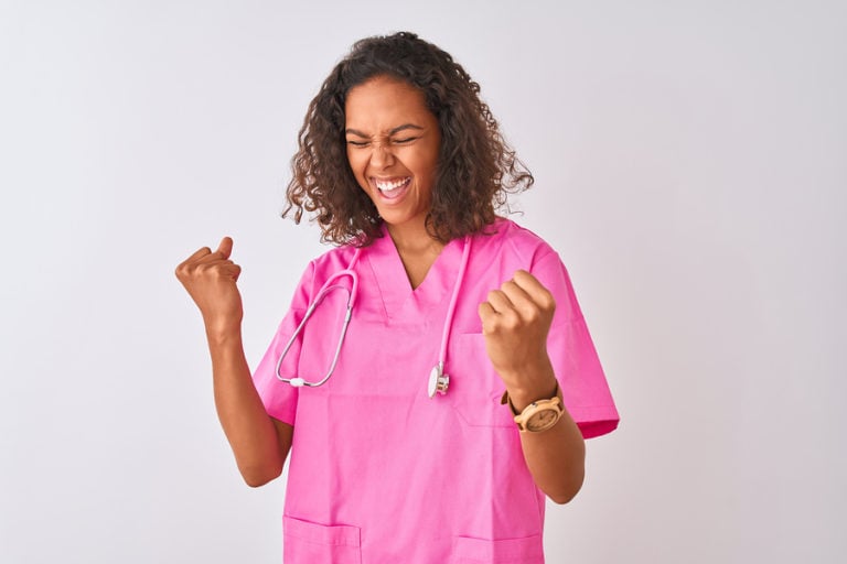 Young nurse wearing pink scrubs with stethoscope