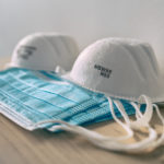 Clean surgical masks and N95 respirators sitting on table