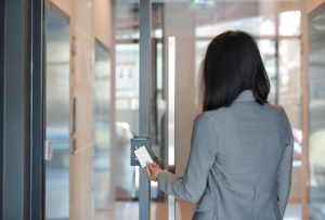 Young business woman holding keycard to get into