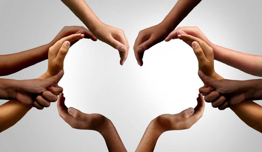 Many hands together forming heart