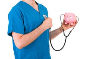 Nurse holding stethoscope from piggy bank to chest