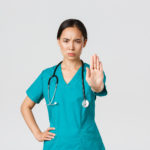 Nurse holding up hand to say stop