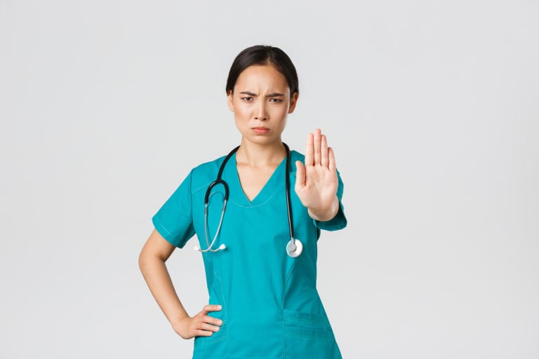 Nurse holding up hand to say stop