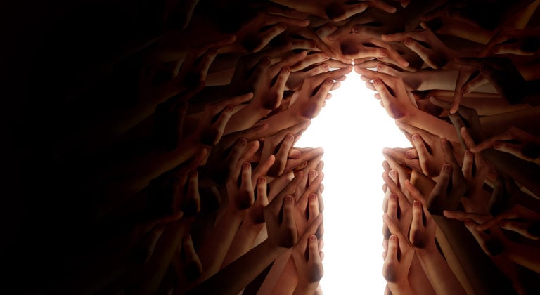 Light arrow pointing up surrounded by hands.
