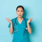 Nurses holding up hands in confused posture.