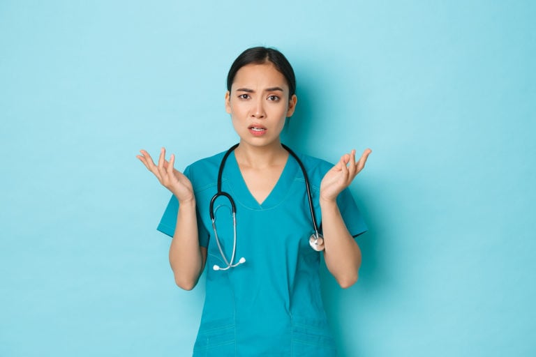 Nurses holding up hands in confused posture.