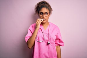 Anxious nurses biting finger nails.