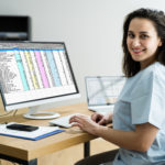Woman nurse studying at her computer.