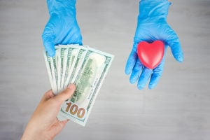 Nurse's gloves with paper money