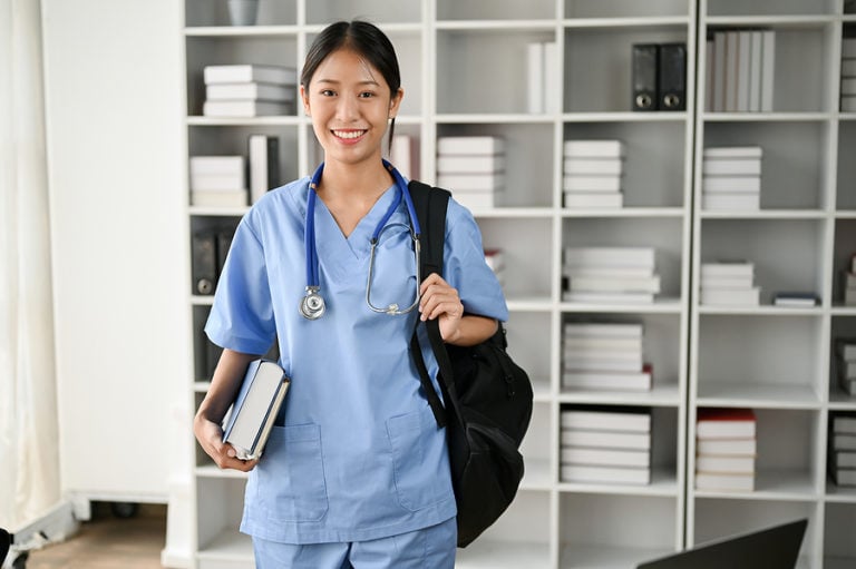 RN to BSN nursing student with backpack and books