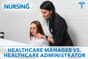 Healthcare Manager and Healthcare administrator working together on a computer in a medical office.